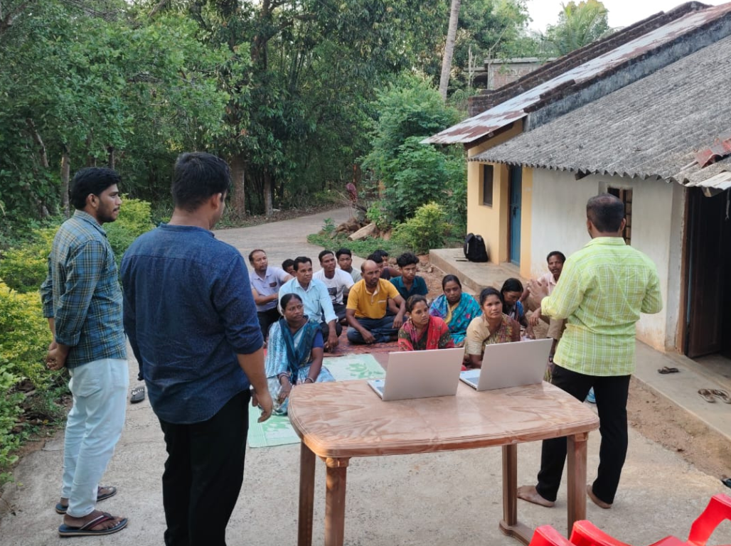 A village session with laptops set up in the open