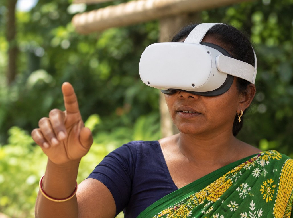 A woman exploring a VanaDrishti VR module outdoors