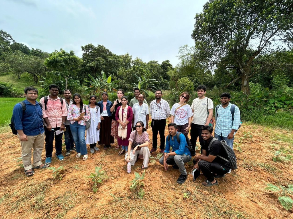 Group of students and facilitators together on a field slope after a session