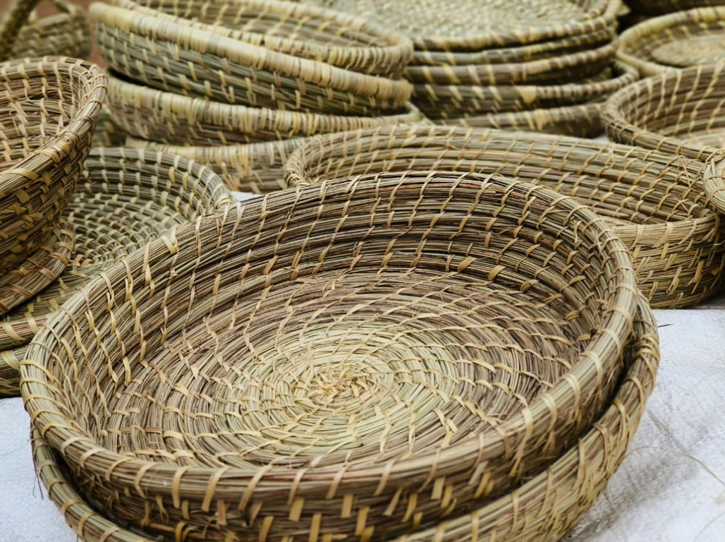 Stacked golden grass baskets and trays