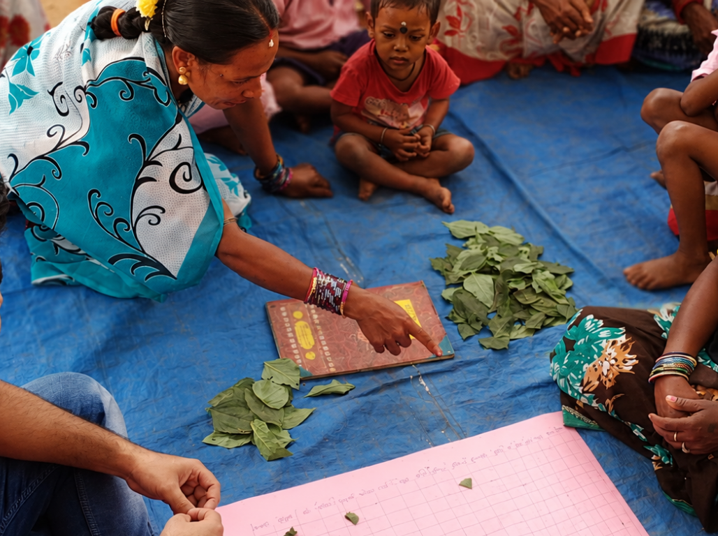 Women documenting leaves and seeds during a participatory workshop