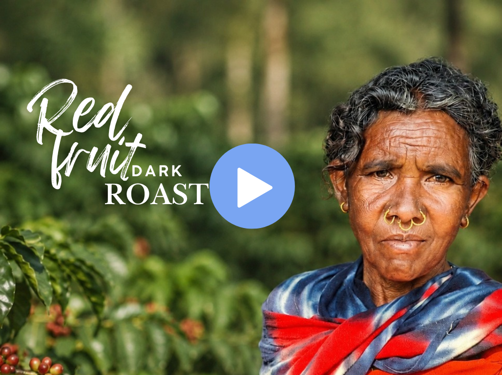 A coffee grower standing among coffee bushes in Araku