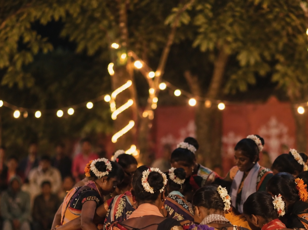 Women with flowers in their hair dancing together under festival lights