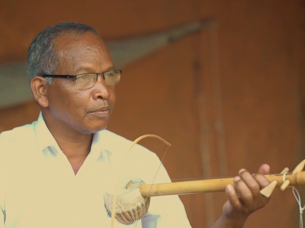 A musician playing a traditional single-string bowed instrument