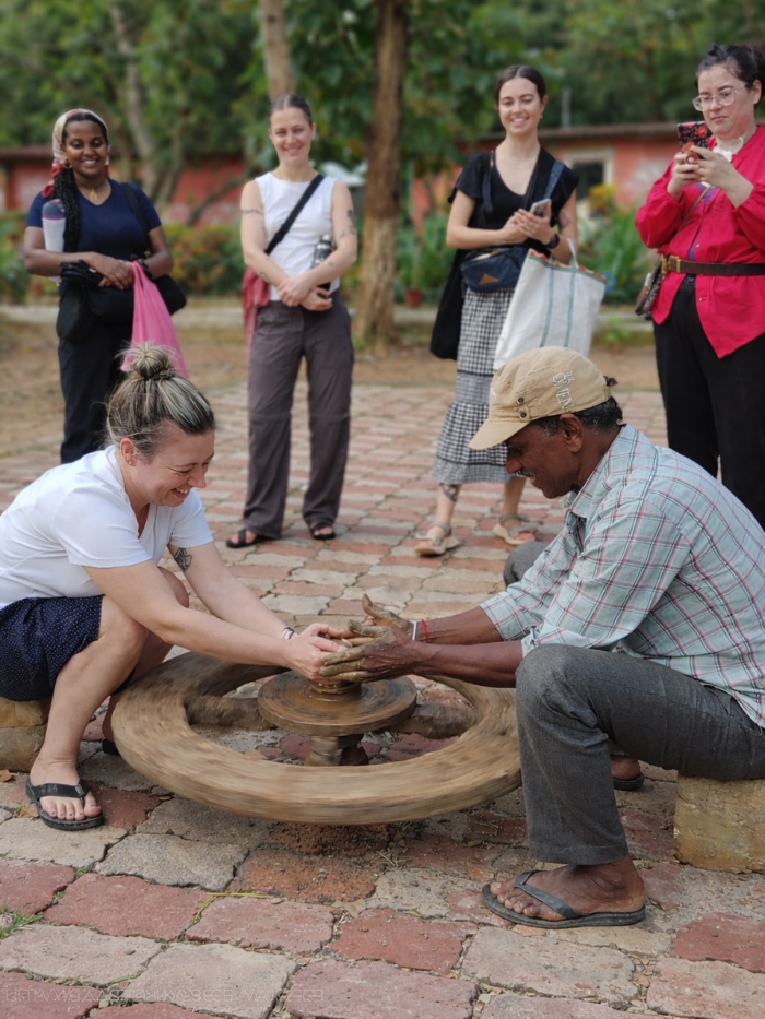 services-03 A woman in traditional tribal attire with intricate beadwork and accessories, outdoors.